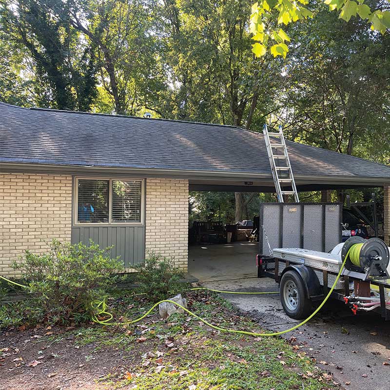 Black streaks algae on roof before in Matthews